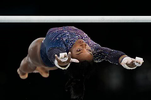 Simone Biles practices the uneven bars